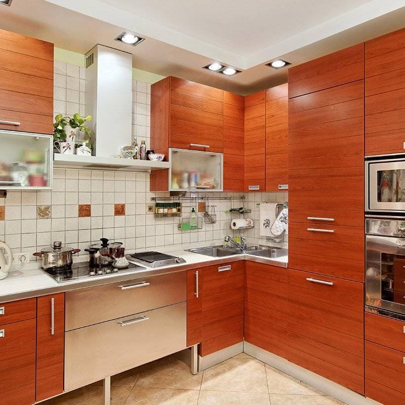 Corner kitchen cabinet in wooden finish with steel chimney and drawers is ideal for small kitchen