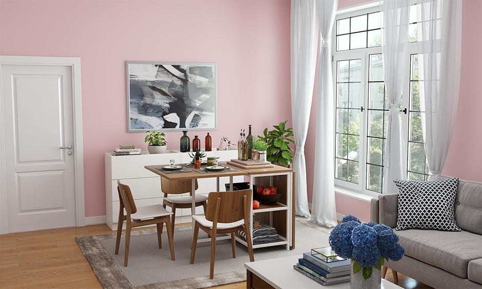 Pink walls combined with ivory accents create trendy colour shades for the drawing room, evoking warmth.