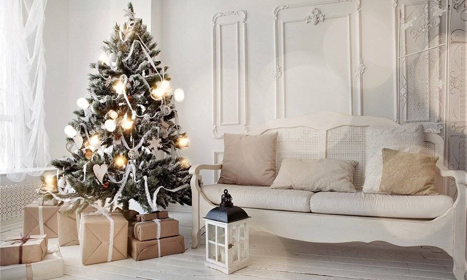 Decorating christmas tree with white ribbon, snow-clad, & ornament